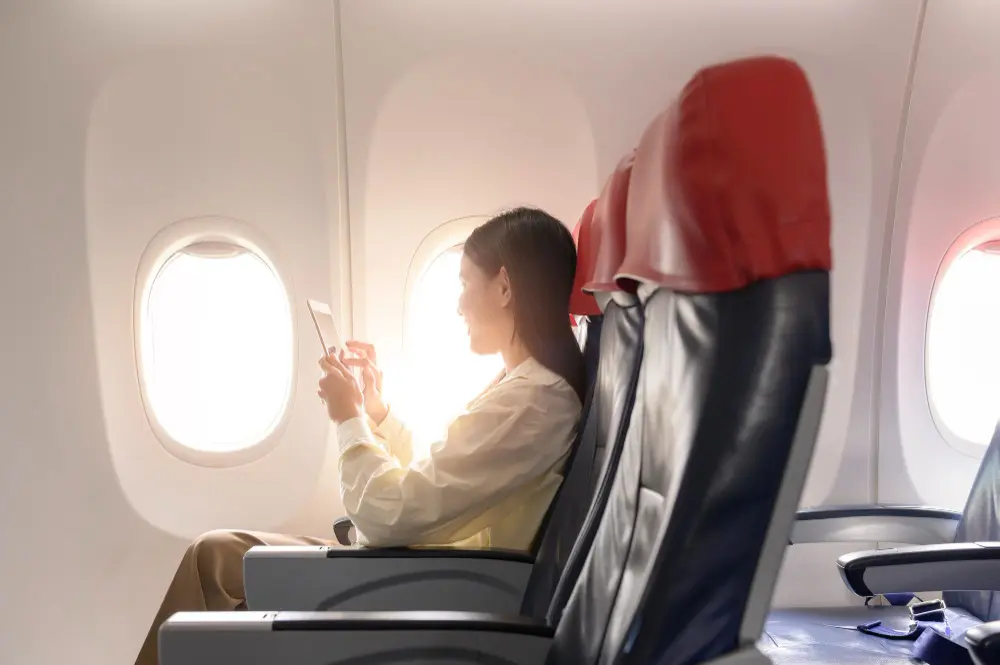 beautiful-asian-woman-is-working-with-smartphone-tablet-airplane-1