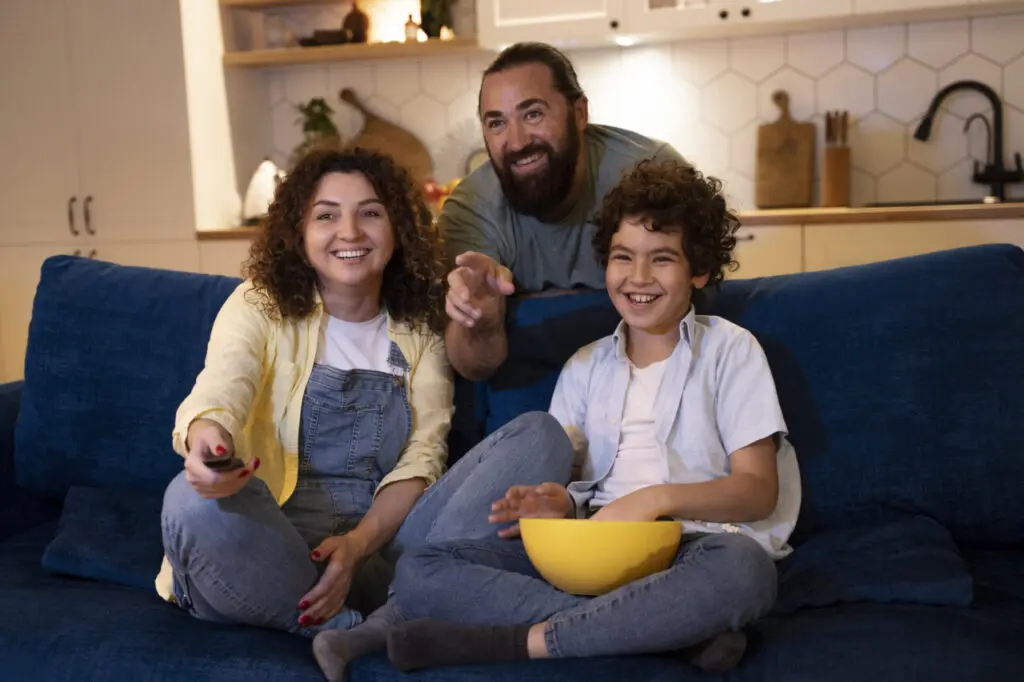close-up-child-watching-movies-with-parents