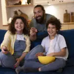 close-up-child-watching-movies-with-parents