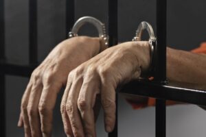 close-up-hand-wearing-cuffs-jail