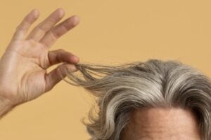 elder-man-holding-his-gray-hair