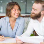 Cheerful office employees flirting and joking