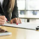 brunette-businesswoman-writing-document