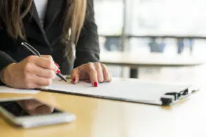 brunette-businesswoman-writing-document