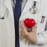 doctor-showing-plastic-heart