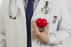 doctor-showing-plastic-heart