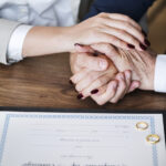 Married elderly couple with marriage certificate