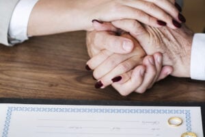 Married elderly couple with marriage certificate