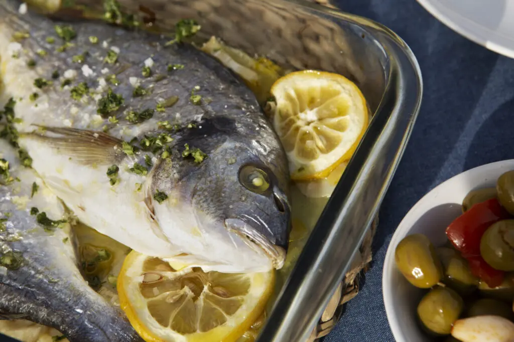 tasty-seabream-with-lemons-high-angle