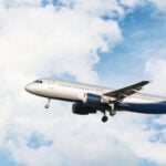 Airplane flying in a cloudy sky