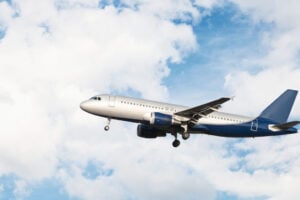 Airplane flying in a cloudy sky