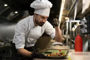 chef-cooking-kitchen-while-wearing-professional-attire