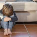 little-boy-outdoors-upset-holding-his-toy