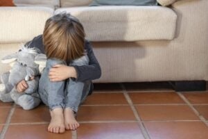 little-boy-outdoors-upset-holding-his-toy