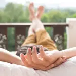 Young man relax on bed and enjoying mountain view