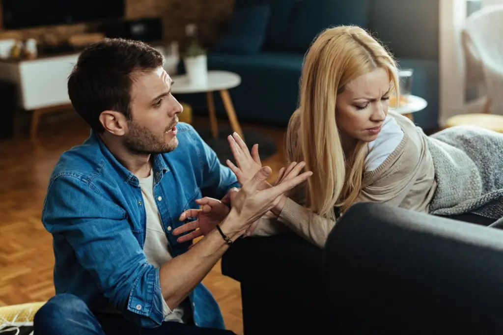 couple-with-relationship-difficulties-having-conflict-while-talking-living-room