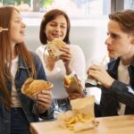 group-friends-eating-fast-food-together