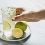 lemonade-glass-limes-bamble-background