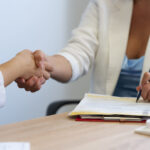 women-shaking-hands-side-view