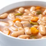 Chickpeas soup with vegetables in bowl isolated on white backgro