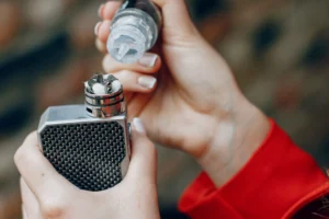 Stylish young girl  in a city with vape