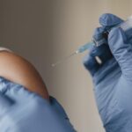 medico-com-luvas-administrando-vacina-para-crianca