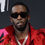 108770333-files-files-us-producer-musician-sean-diddy-combs-poses-with-the-global-icon-award-in-the