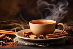 A cozy cup of cinnamon tea with cinnamon sticks and powder besid
