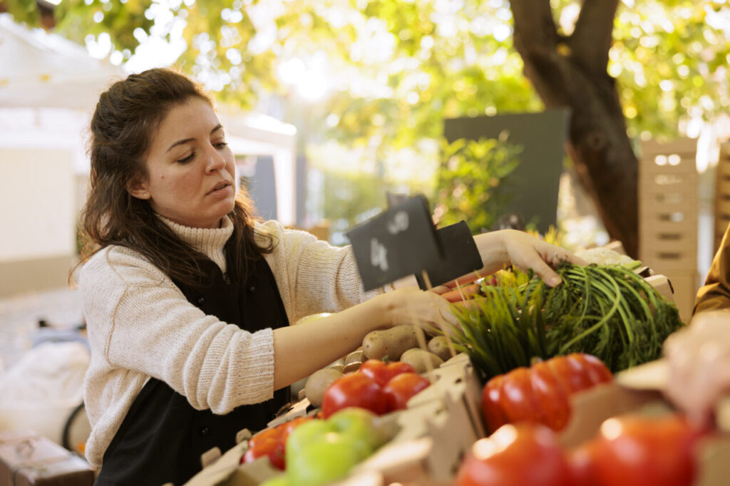 Vendor checking quality of organic items
