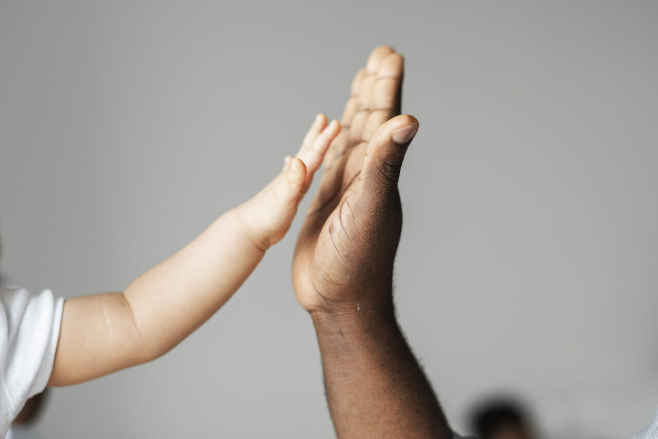 Small and big hands doing a high five