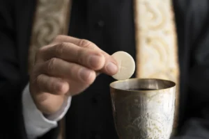 feche-mao-segurando-eucaristia