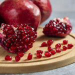 Sliced ripe pomegranate on a wooden board