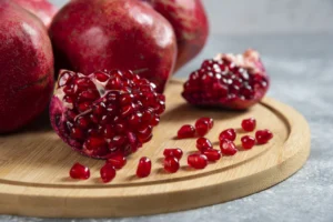 Sliced ripe pomegranate on a wooden board