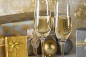 Two champagne flutes and Christmas gifts