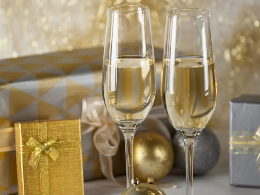 Two champagne flutes and Christmas gifts