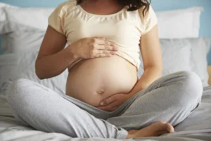 Naked pregnant abdomen of young woman