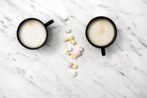 top-view-cups-coffee-marble-background