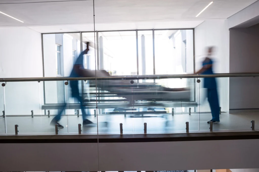 Team of doctors taking pregnant woman to operation theatre in the hospital